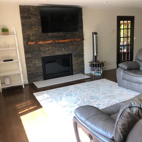 Living room with stone fireplace after cleaning